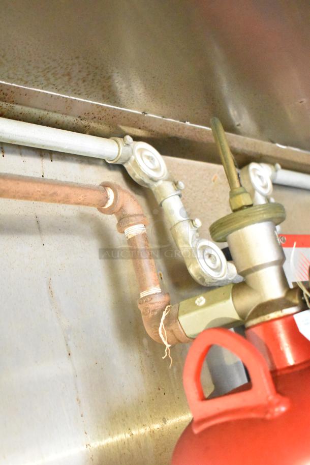 Interior plumbing and fixtures of a 2019 Stuff4less 24' food trailer, showing pipes and connections for kitchen setup.