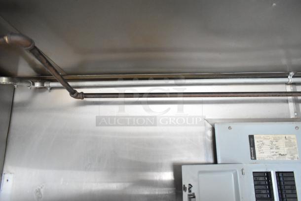 Interior view of Stuff4less 24' mobile kitchen trailer. Visible pipes and electrical panel. Ready for equipment installation.