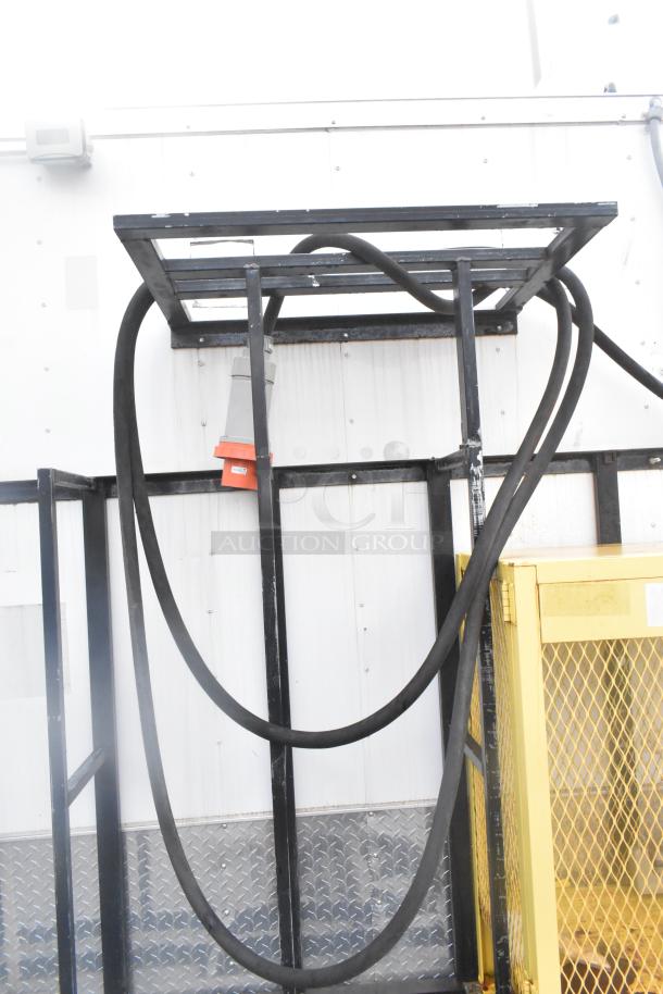 Metal frame with black hoses connected, part of Stuff4less 24' fast food trailer support structure, showing wiring components.