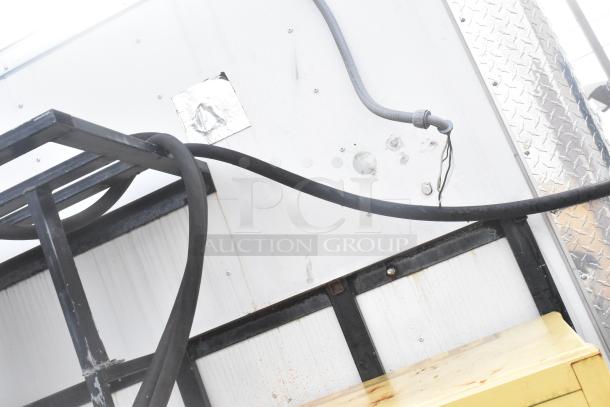 Industrial detail of Stuff4less 24' fast food trailer exterior with visible wiring and metal framework.