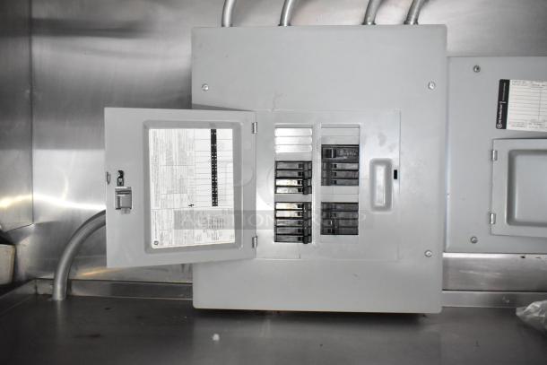 Electrical panel in Stuff4less 24' fast food trailer. Includes breaker switches, circuit labels, and metal casing.