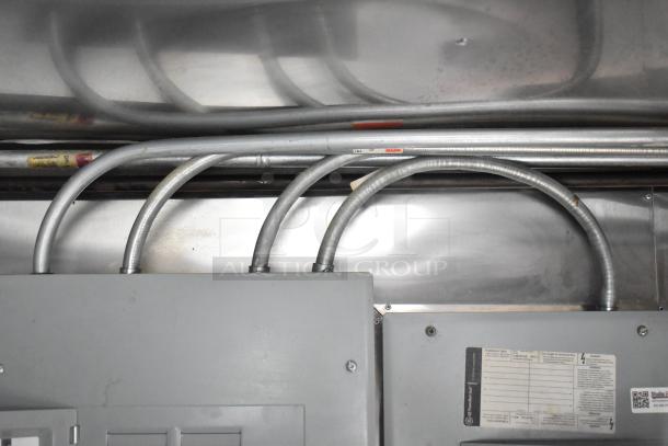 Electrical controls and conduits inside a Stuff4less 24' corporate spec fast food trailer, showcasing infrastructure setup.