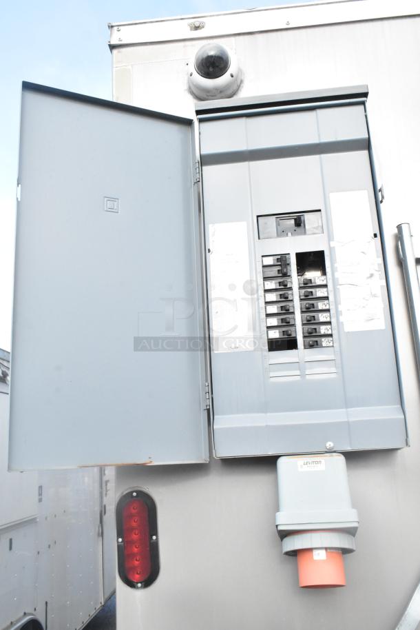 Electrical panel on the Nationwide 24' retail trailer. Features visible circuit breakers and an external connection port.