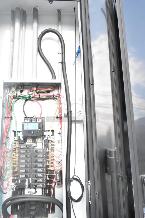 Interior view of electrical panel in a new SDG 20' food trailer. Features wiring setup, ready for kitchen equipment installation.