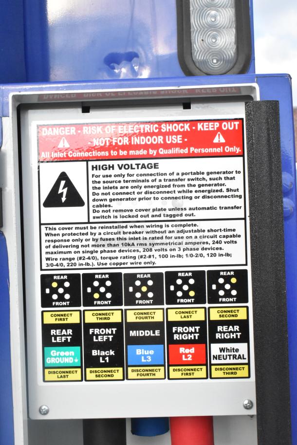 A high-voltage warning panel on a 2021 Rock Solid Cargo fast food trailer, indicating electric risk and connection instructions.