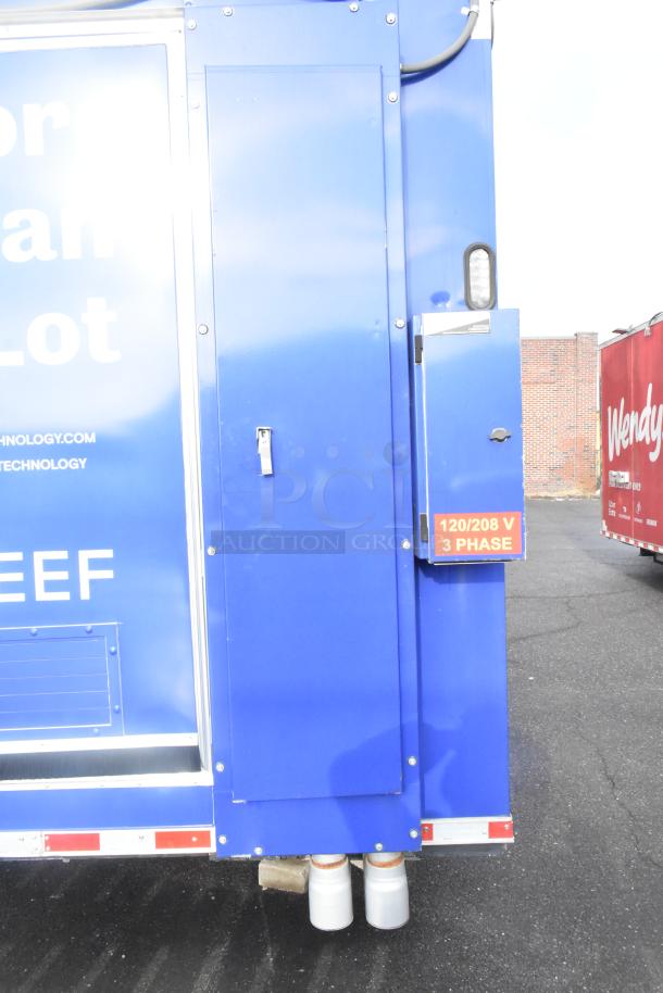 Blue 2021 Rock Solid Cargo 24' mobile kitchen trailer, new condition, setup includes commercial-grade equipment. Visible 120/208 V 3 Phase label.