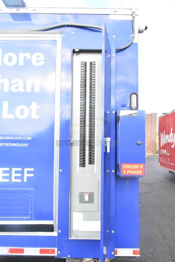 Alt text: Blue Rock Solid Cargo 2021 fast food trailer with electrical panel open and "120/208 V 3 Phase" label visible.
