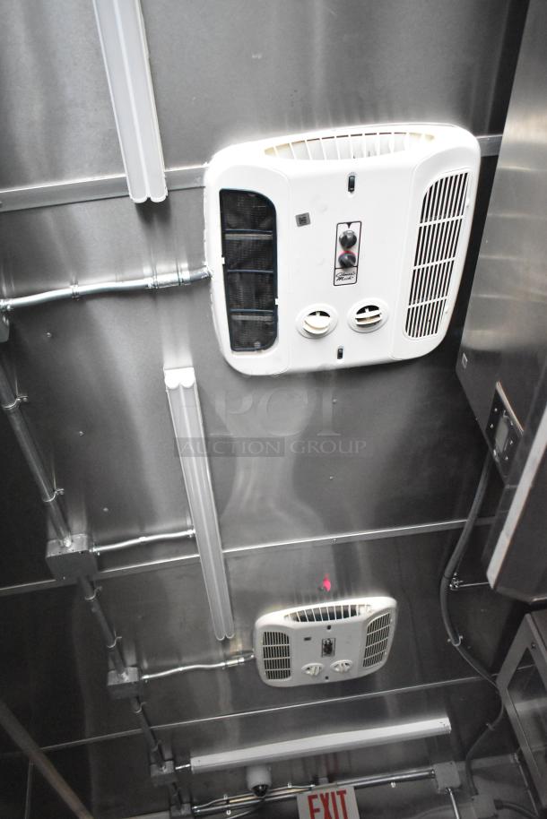 New 2021 Rock Solid Cargo 24' mobile kitchen trailer interior, featuring ceiling-mounted ventilation systems and overhead lighting.