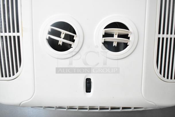 Air vent panel in white with dual circular adjustable vents and control knob.