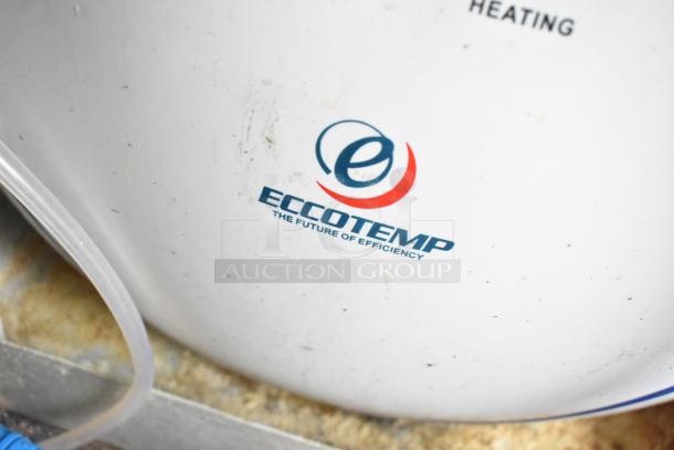 Eccotemp branding on the side of a tank indicating efficiency in heating systems. Surface shows minor wear.