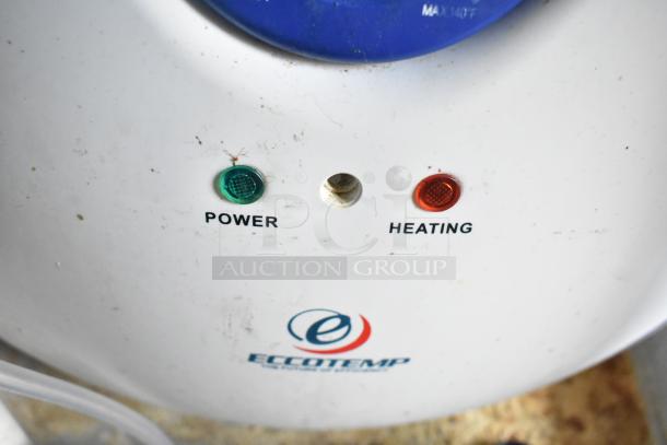 Alt text: Eccotemp water heater control panel with green power light and red heating light illuminated.