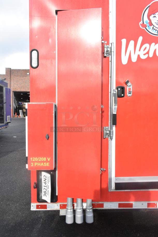 Red Rock Solid Cargo 28' fast food trailer, Wendy's branding, equipped with commercial appliances, electrical panel labeled 120/208V 3 Phase.