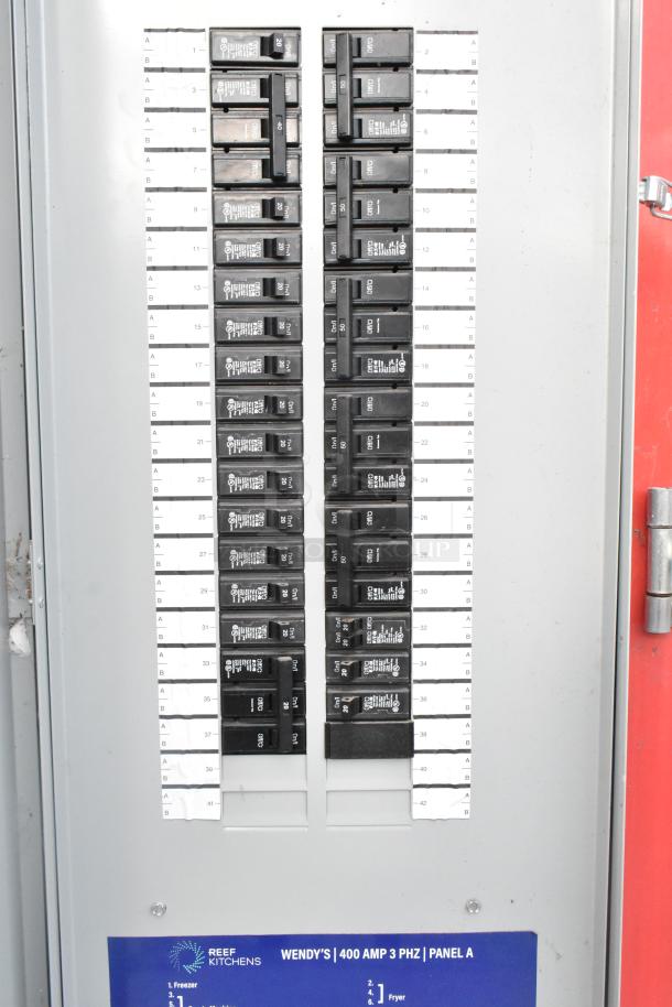 Electrical panel of Rock Solid Cargo mobile kitchen trailer, 400 AMP 3 PHZ, labeled for Wendy's setup, Reef Kitchens branding.