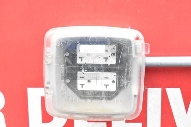 Clear outdoor electrical outlet cover on red Rock Solid Cargo 28' Wendy's Fast Food Trailer.