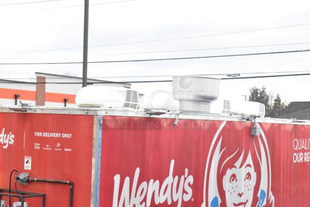 28' Wendy's fast food trailer, Rock Solid Cargo, equipped with commercial kitchen setup. Features delivery service logos.