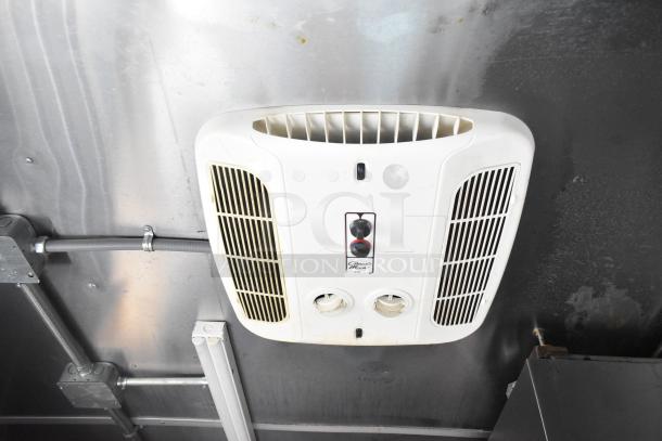 Ceiling-mounted air vent in Rock Solid Cargo 28' fast food trailer, featuring power switches and ventilation grills.