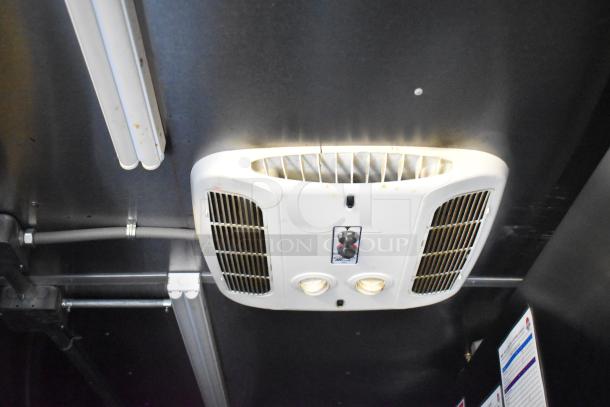 Ceiling-mounted vent and lighting in Rock Solid Cargo 28' fast food trailer, featuring control knob and ventilation grilles.
