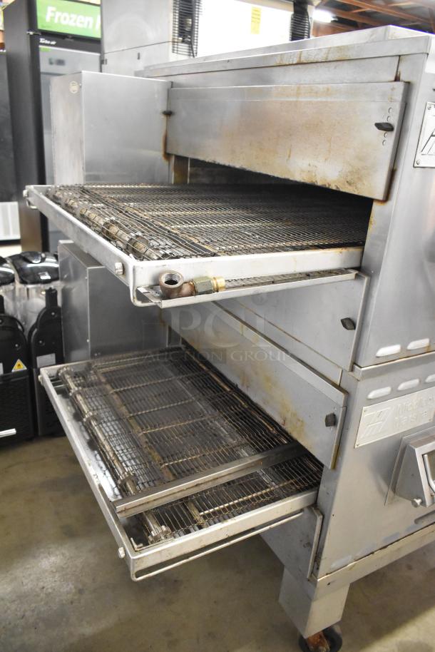 Middleby Marshall PS540G stainless steel conveyor pizza oven, natural gas, 110,000 BTU, on commercial casters, visible wear.