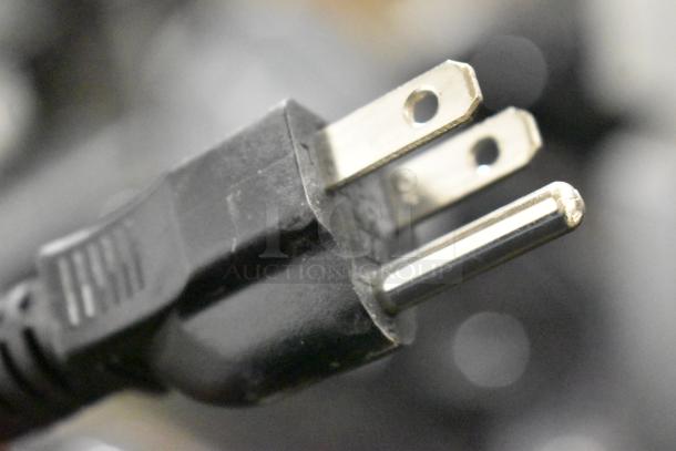 Close-up of a three-prong power plug, associated with the Galaxy 177GSM1 beverage machine, 120 volts, single-phase.