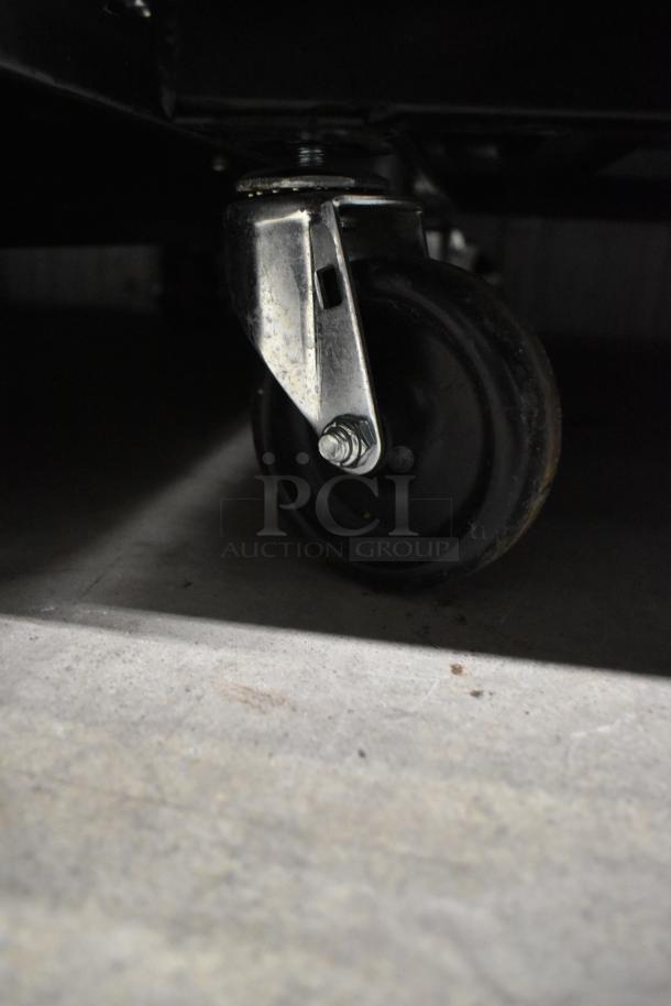 Close-up of a caster wheel on the 2021 True T-23F-HC commercial freezer, poly-coated racks, stainless steel.