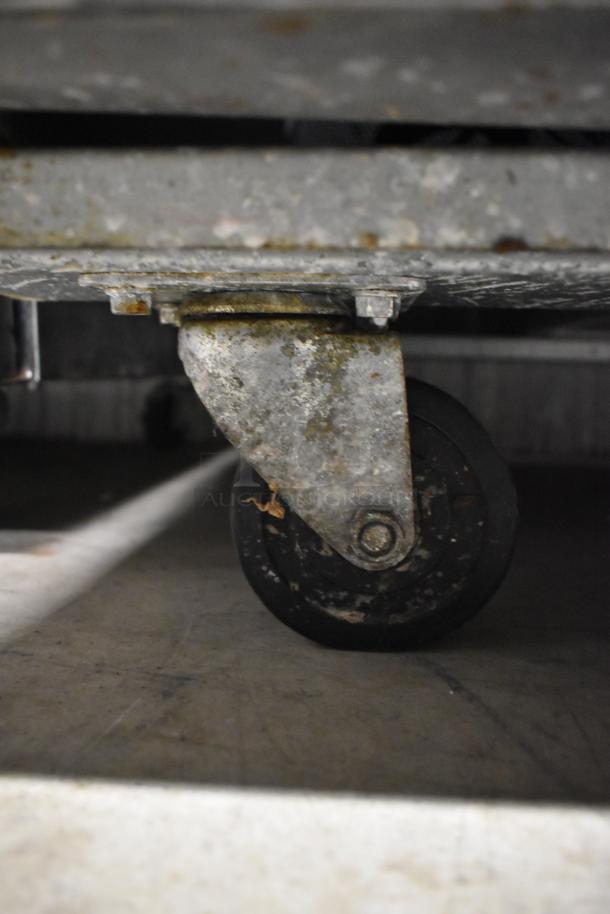 Worn caster on Avantco 178A49FHC commercial freezer, showing rust and signs of use.