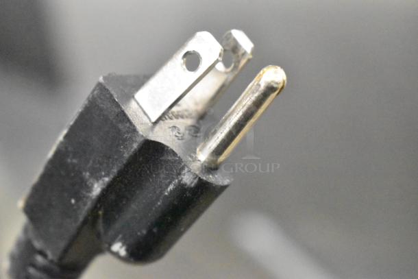 Close-up of the plug of a 2018 Jun-Air 87R-4MN1-HSBHH nitrogen generator showing standard prongs in good condition.