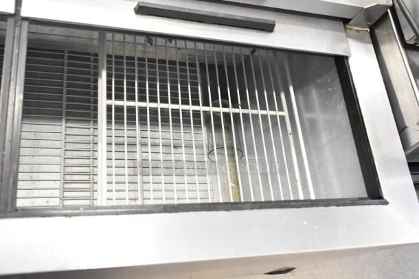 Beverage Air GF48L stainless steel commercial back bar bottle cooler with two sliding lids, interior view, good condition.