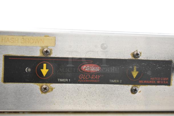 Hatco Glo-Ray heated holding cabinet control panel showing timers. Worn condition with "HASH BROWN" label.