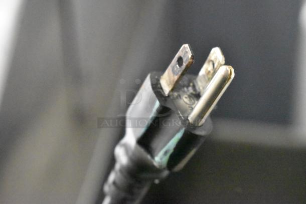 Close-up view of a three-pronged electrical plug on the Avantco 178SSPT71MHC sandwich salad prep table.