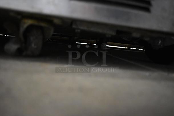 Delfield 4448N-12 stainless steel prep table underside view showing commercial casters, ensuring mobility and stability.