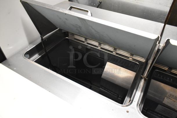 Delfield 4448N-12 stainless steel sandwich prep table with open lid, commercial casters, 115V, 1 phase.