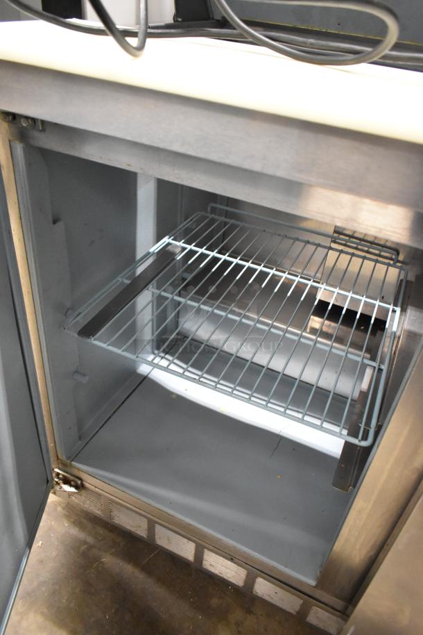 Delfield 4448N-12 stainless steel commercial sandwich salad prep table, interior wire shelf, on commercial casters.