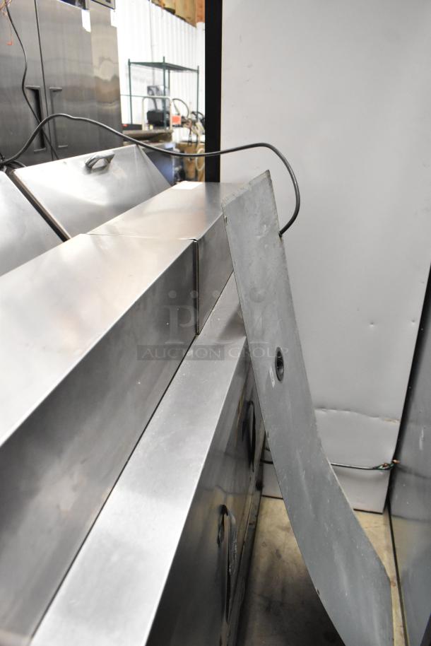 Delfield 4448N-12 stainless steel sandwich prep table, with mega top and commercial casters. Some panels removed.