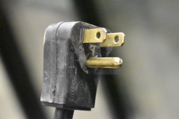A close-up of a plug for a 2019 Habco SE18 commercial cooler, showing a three-prong electrical connector.