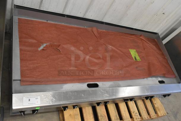 Brand new Garland stainless steel commercial countertop flat top griddle, visible protective covering, minor dents.