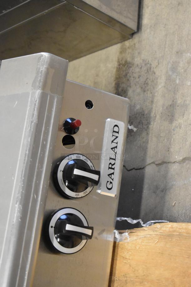 Brand new Garland stainless steel countertop griddle, scratch and dent condition, visible controls and Garland label.