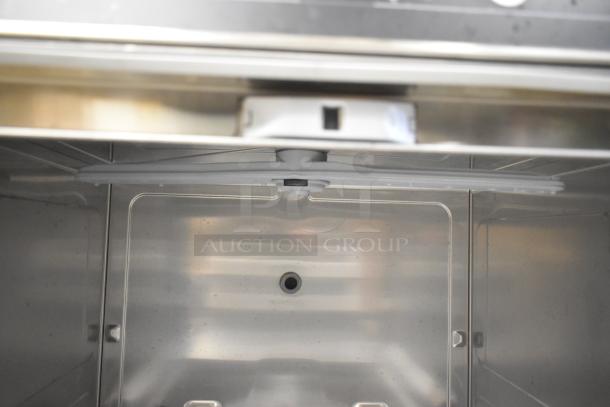 Brand new 2025 Hobart CUH stainless steel commercial undercounter dishwasher interior. Scratch and dent condition.