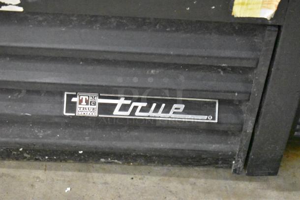 True GDM-41SL-60-LD logo on metal commercial reach-in cooler, poly-coated racks, 115 volts, 1 phase.