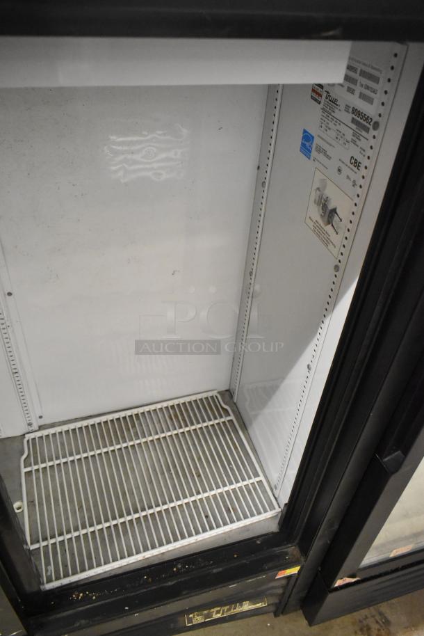 True GDM-41SL-54-LD commercial 2-door cooler. Features poly-coated rack, visible label with voltage and model details.