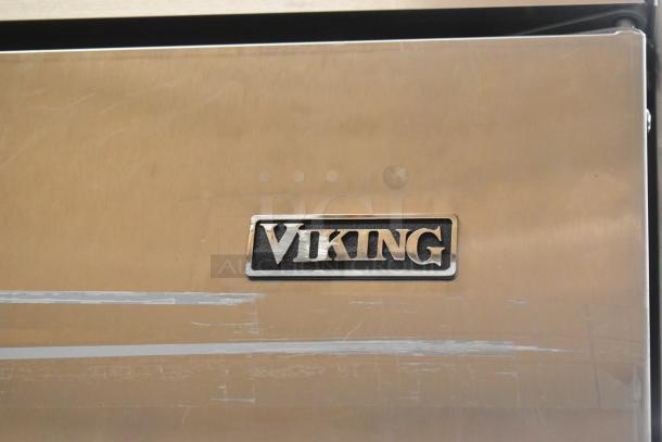 Viking stainless steel reach-in cooler with freezer drawer, commercial grade, 115V, scratched surface, Viking logo visible.