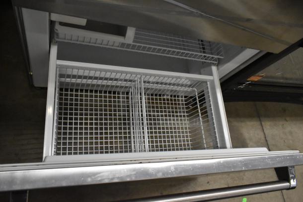 Viking stainless steel commercial reach-in cooler with freezer drawer, 115V, 1 Phase. Features grid storage compartments.