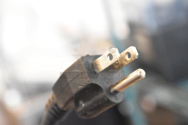 Close-up of a three-pronged power plug for a 2022 Vita-Mix VM0145 Commercial Blender, showing metal prongs.