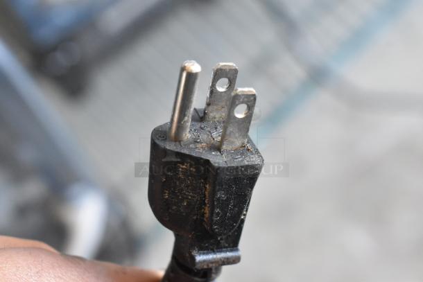 Close-up of a power plug, likely for a 2022 Vita-Mix VM0145 Commercial Blender, showing visible wear.