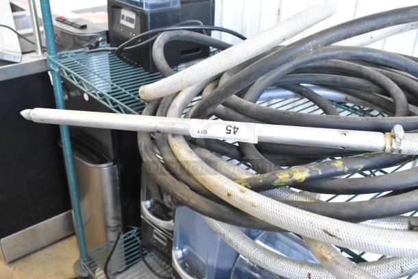 Coiled black and white hoses, some wear visible, labeled "45 QTY" on attached tag. Auction for two hoses.