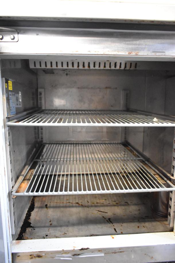 Asber APTP 46 stainless steel commercial pizza prep table, interior view, two wire shelves, visible wear, 115V, 1-phase.