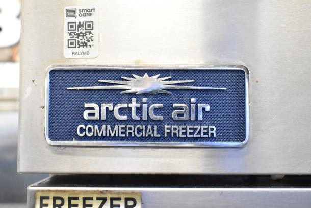 Arctic Air AF23Z stainless steel commercial freezer with logo and QR code tag, features poly-coated racks, 115V.