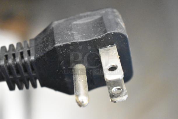 Power plug for Arctic Air AF23Z stainless steel commercial freezer, 115 volts, 1 phase, shown in close-up detail.