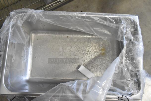 Brand new stainless steel drop-in bin, partially wrapped in plastic. Item is part of a scratch and dent auction lot.