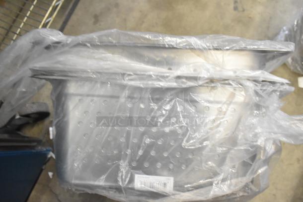 Brand new scratch and dent stainless steel drop-in bins, including perforated 1/1x6, wrapped in plastic.