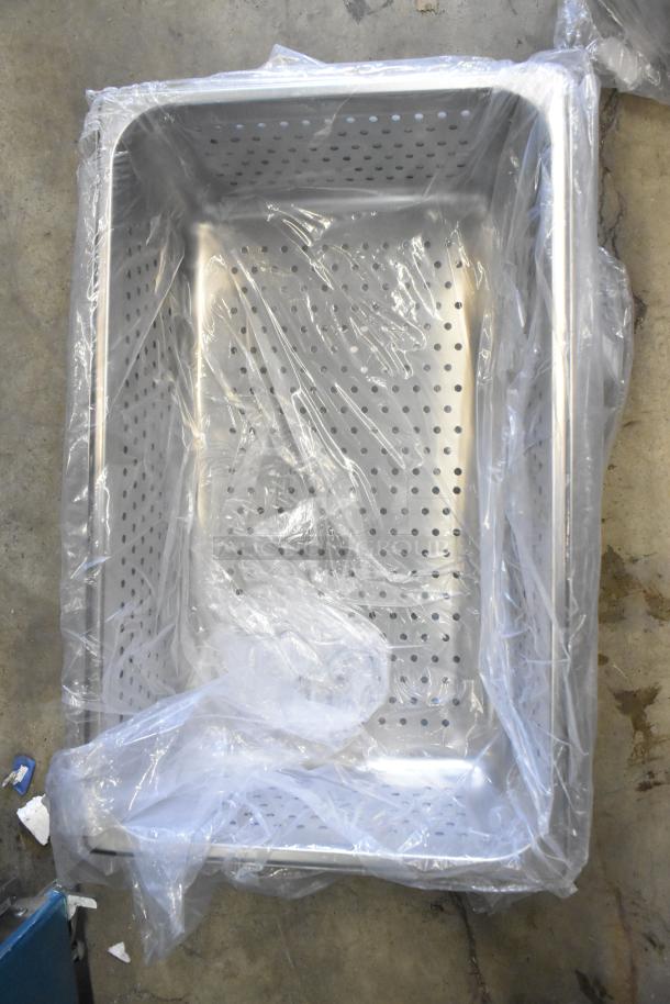 Stainless steel perforated drop-in bin in original packaging, new condition, suitable for commercial use.